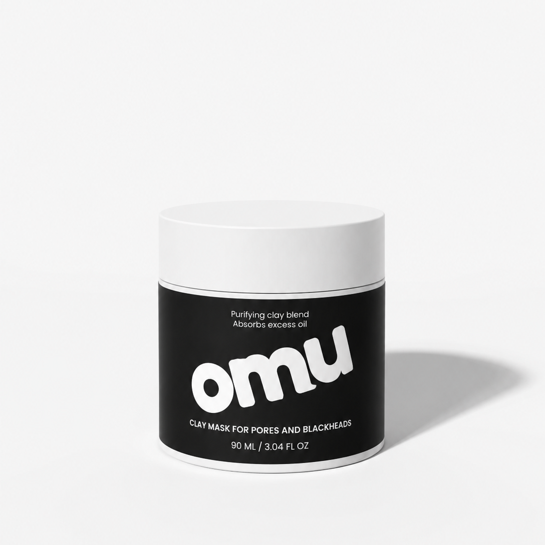 Black and white jar of OMU clay mask on a white background